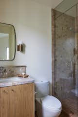 Secondary bathroom with marble counters, oak cabinets and zellige tile. 