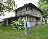 Exterior, House Building Type, Gable RoofLine, Stucco Siding Material, and Shingles Roof Material Jason Loper and Michael Schreiber in front of their home, the Frank Lloyd Wright-designed Meier House in Monona, Iowa.  Photo 1 of 13 in The Meier House by Michael Schreiber