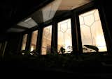 Windows, Wood, and Casement Window Type An exterior view of the lighted zinc game windows at night.   Photo 12 of 13 in The Meier House by Michael Schreiber