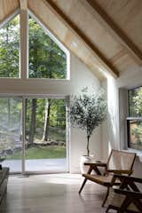 Living room with pine ceiling and 12-foot window. 