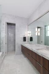 Master bathroom. Marble floors and walls, Quartzite top, Kohler fixtures, and restoration hardware lights. 