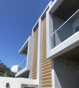 Outdoor and Back Yard The blue sky of South Florida makes the straight lines of this house appear clear and crisp.  Photo 12 of 16 in Silver Bluff Townhouse - Miami by PRZ Design + Build