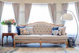 A classic shape European style sofa with a chinoiserie curved shape standing lamp and blue & white objects in the living room; a perfect modern fusion chinoiserie style 