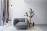 The linen curtain folding over the concrete stairs welcomes our client home. Storage space was created under the stairs and made accessible by a secret door.