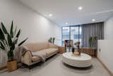 We love the balance between the soothing beige fabric sofa and the monolithic white concrete coffee table. Together combined with our custom-design balustrade creates a cozy yet open living space.
