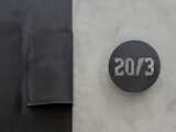 To create a special entry moment, we mounted our laser cut steel house address signage on a smooth grey concrete rendered wall.