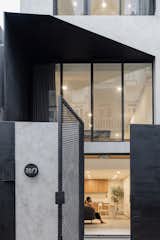 The choice of material was driven by what felt important to our client: Safety and a contrast to the surroundings while being minimal. The backdrop is created by a smooth grey render balanced by different black steel textures. Meanwhile, the inside is warmed up by custom made oak and rattan joinery.