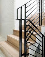 Staircase, Wood Tread, and Metal Railing After: Updated tread and risers in squared white oak with minimal painted steel railing  Photo 7 of 24 in Before and After: A Faded Mid-Century Becomes Luminous by HxH Architects PLLC