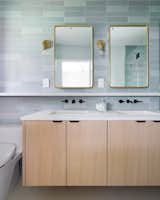 The primary bath: Showing white oak vanity with a mix of black and gold fixtures and hardware