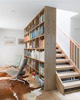 The bookcase flanks the stair at the first level