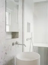 Bathroom fixtures complement surface finishes to inspire a feeling of cleanliness.