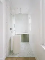 An efficient en-suite bathroom extends from the bedroom.