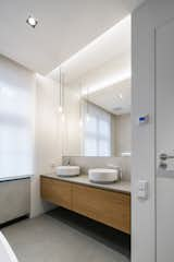 Bath Room, Stone Counter, Vessel Sink, Pendant Lighting, and Ceiling Lighting  Photo 16 of 27 in Art Maisonette in Letná by esté architekti