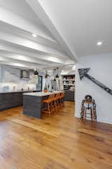 The white beams lead you onto the new kitchen space, and a vintage arrow off a sign lead you not the starting point of the beams with a touch of whimsy