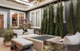 Courtyard lounge surrounded by architectural evergreen and selection of containers provide levels and soften views from inside and outside of the home. 