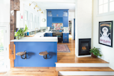 Kitchen, Undermount Sink, Medium Hardwood Floor, Wall Lighting, Range Hood, Concrete Counter, Colorful Cabinet, Mirror Backsplashe, and Range Kitchen  Photo 8 of 24 in Cambridge Townhouse by SKA