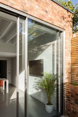 The arrangement of spaces is key to the design, ensuring that each room keeps an abundance of natural light and ventilation.  Photo 5 of 14 in 947 Square Feet of House Fit Between a London Victorian Terrace Home and a Substation