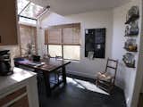 The after dining nook: The pantry cabinet was removed (opening up the space) and replaced by  open shelving and a magnetic blackboard that keeps the freezer organized, menus posted weekly and a running list for the grocery store trip. The walls are BM Swiss Coffee.