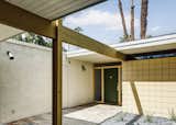 Doors, Exterior, and Wood Front Walkway with courtyard garden and original Stilnovo light fixtures.  Photo 4 of 12 in A Midcentury-Modern Home in Palm Desert Is Preserved to a T from Palm Desert Mid Century Modern Restoration