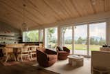 An expansive glass wall connects the interior spaces to distant views of the Boulder Flatirons.