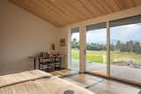 Primary Bedroom with an operable glass wall opening up to distant views of the Boulder Flatirons.