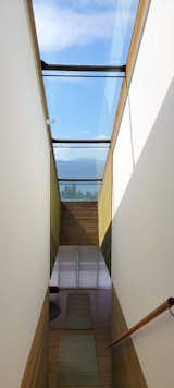 A skylight illuminates the stairwell leading from the foyer down to the main level.