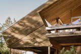 Decks about on three sides of this multi-level masterpiece in wood.