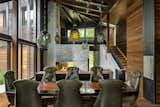 Dining Room, Pendant Lighting, Chair, Table, Medium Hardwood Floor, Two-Sided Fireplace, and Wood Burning Fireplace  Photo 18 of 30 in August Moon by SPAN Architecture