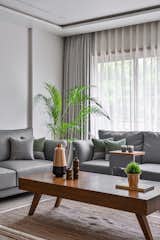 The grey tones diffusing all over the space with the natural hues of wood play a key role in maintaining the harmony of the space. 