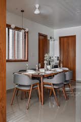 The dining area includes similar tones with a clutter-free layout and clean finishes.
