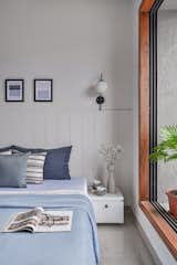 other bedroom is designed to keep the future perspective and changes in the family pattern in upcoming years. The play of white and blue is rooted in a colour palette as a future kids room. Similar to the other room the arched shape shelf breaks the rigid geometrical play depicting the fluxional nature of the kid. 