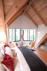 Bedroom overlooking the forest and Lake with beautiful fireplace and vaulted ceilings. 