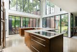 Inside the 4,314-square-foot home, double-story glass panels usher in ample natural light.  Photo 3 of 13 in A Restored Midcentury With an 1,800-Square-Foot Addition Seeks $740K in Illinois from Contemporary Mid Century