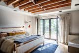 Bedroom, Medium Hardwood Floor, Bench, Bed, Recessed Lighting, and Accent Lighting  Photo 9 of 18 in Rigorvive House by John Wingfelder Architect