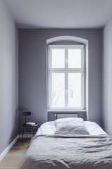The small but cozy bedroom.  Photo 5 of 6 in For €494K, Live in This Revived 20th-Century Berlin Apartment With Lilac-Painted Walls