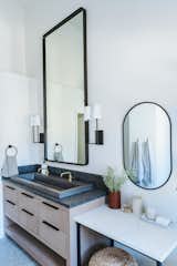 Clean lines carry throughout the bathroom, with Native Trails' Trough 4819 NativeStone sink serving as the centerpiece. 