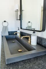 A closeup shot of the Native Trails Trough 4819 NativeStone Sink -- hand-crafted and sustainable source, it's a timeless element in the space. 