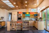 The new kitchen has MCM style all over it. Pops of color and Sarah Burgevin’s ceramic artwork highlight the space. 