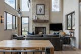 Living Room, Sofa, Pendant Lighting, Ceiling Lighting, Light Hardwood Floor, and Standard Layout Fireplace  Photo 2 of 10 in Perfect Ski Getaway: Somrak Concept + Structure’s Crested Butte Home by Grace Gathright