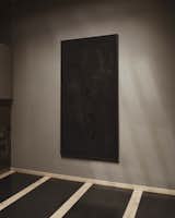 A large black painting by Beatriz Zamora decorates a wall.