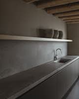 The kitchen design is dark and clean.