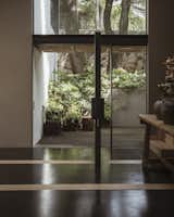 Doors, Interior, Exterior, Metal, Wood, and Swing Door Type A bright double height foyer.  Photos from Tres Árboles House