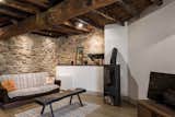 The old storage area was restored and converted into a living room. All the wooden structural elements were kept.