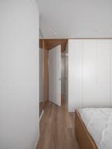 Bedroom, Bed, Ceiling Lighting, and Medium Hardwood Floor Bedroom entrance.  Photo 15 of 28 in Capitaes Abril apartment by estudio AMATAM