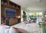 Expanded Living layout with new custom walnut media center and checkerboard Eames Lounge
