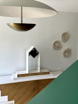 Vintage memphis style console peaks from over bookcase stair rail