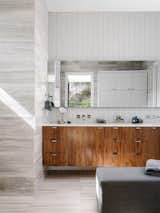 Primary Bathroom - Ann Sacks stacked tile, vein-cut limestone walls and walnut floating vanity