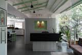 The ceiling pattern breaks the monotony of flat ceiling creating depth and interest of space in and around. The reception at the back is intentionally left at a lower height and not touching the ceiling to give a feel of expanse of space. 