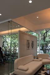 key feature to add to expanse of space is that none of the partition walls extend to the ceiling. A “C” shaped glass panel has been incorporated for These glass panels serve a dual purpose: providing visual continuity and offering an expansive view for those working in the space.