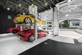 Double-height ceiling three-car garage with two car lifts